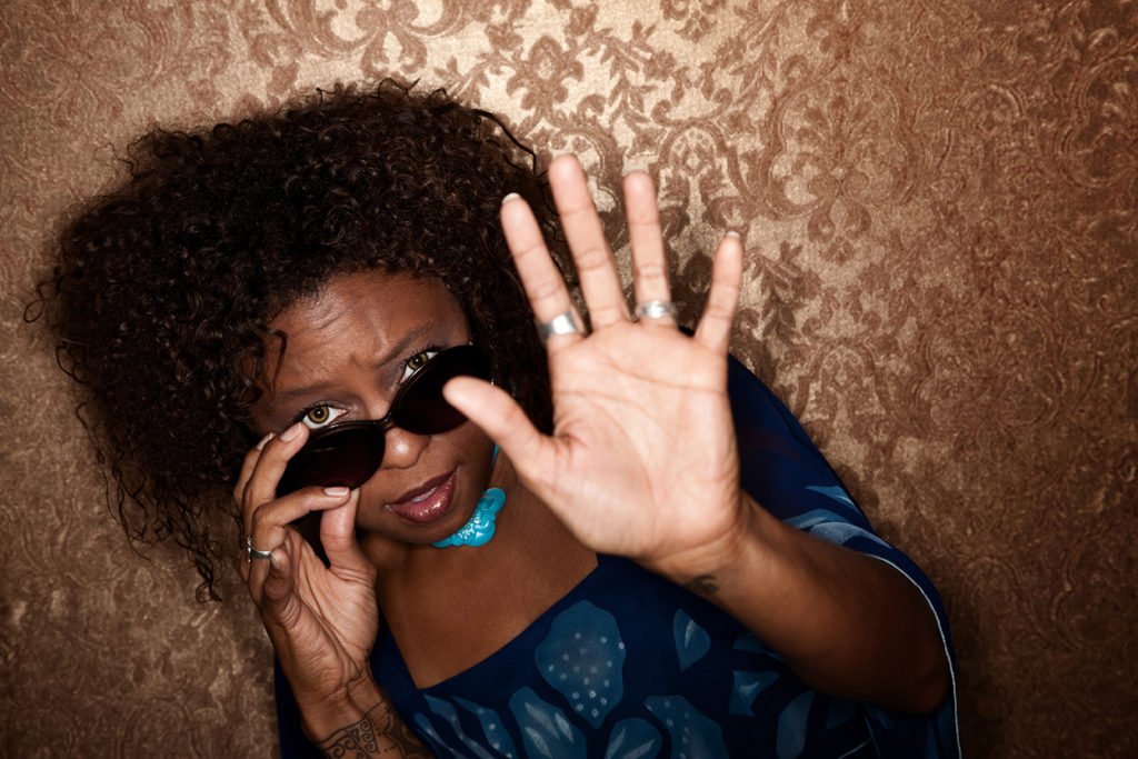 Afrincan American woman caught in a Paparazzi photographer's flash